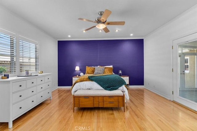 bedroom featuring an accent wall, multiple windows, and light wood-type flooring