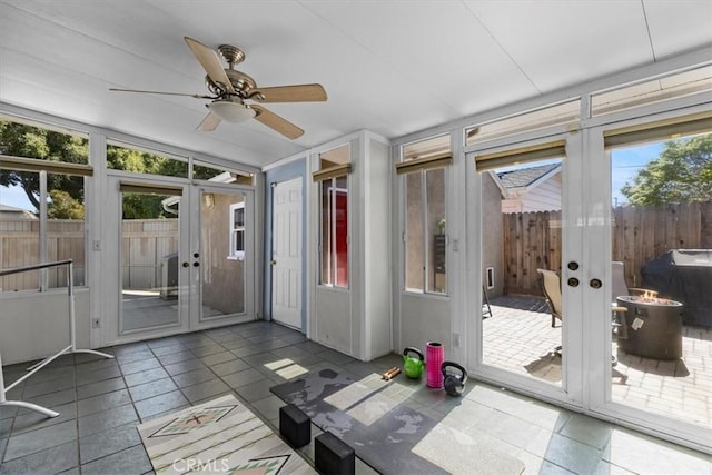 unfurnished sunroom featuring ceiling fan, french doors, and lofted ceiling