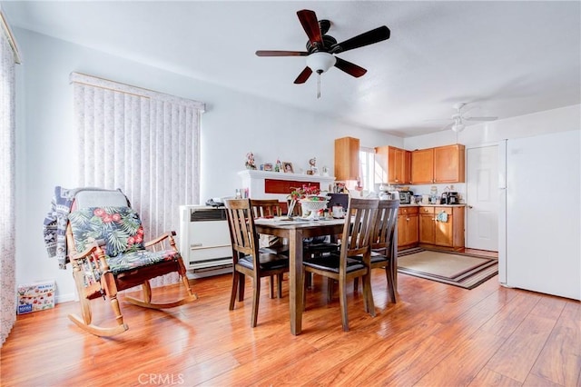 dining room with light wood finished floors and ceiling fan