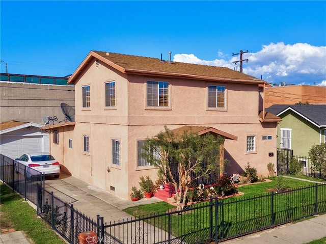 exterior space with a front yard, a garage, a fenced front yard, and stucco siding