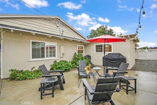 view of patio / terrace featuring a grill and fence