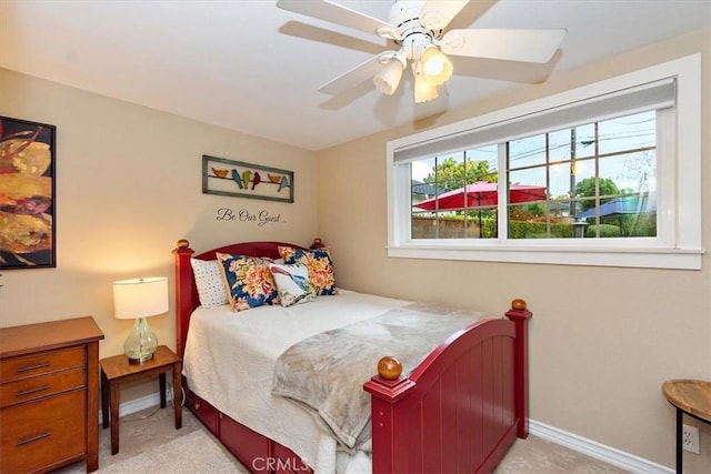 carpeted bedroom with baseboards, multiple windows, and ceiling fan