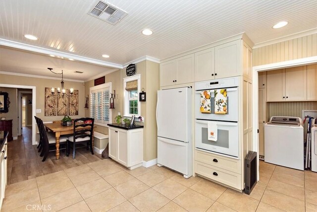 kitchen with white appliances, light tile patterned floors, visible vents, an inviting chandelier, and crown molding