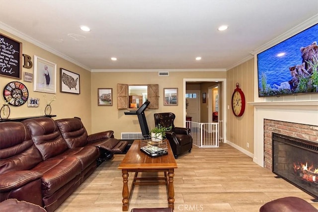 living room with light wood finished floors, visible vents, and crown molding