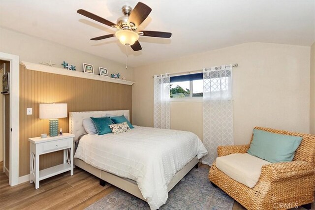 bedroom with a ceiling fan and wood finished floors