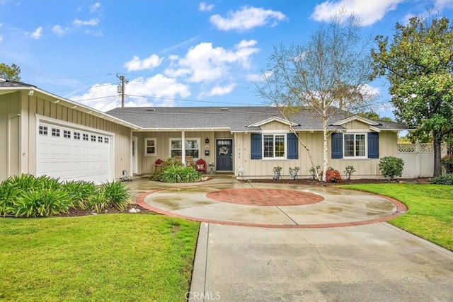 ranch-style home featuring board and batten siding, concrete driveway, a front lawn, and fence