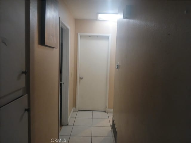 corridor featuring light tile patterned floors and visible vents