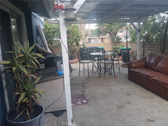 view of patio featuring a fenced backyard, outdoor dining space, and a pergola