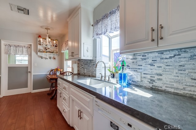 kitchen featuring visible vents, a healthy amount of sunlight, dishwasher, and a sink