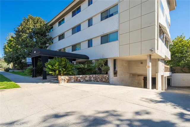 view of building exterior featuring concrete driveway