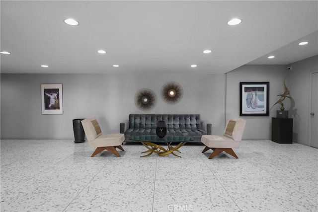 living room with recessed lighting and speckled floor