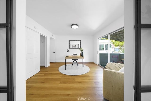 office space with light wood-style flooring and baseboards