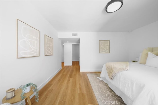 bedroom with visible vents, baseboards, and light wood-style floors