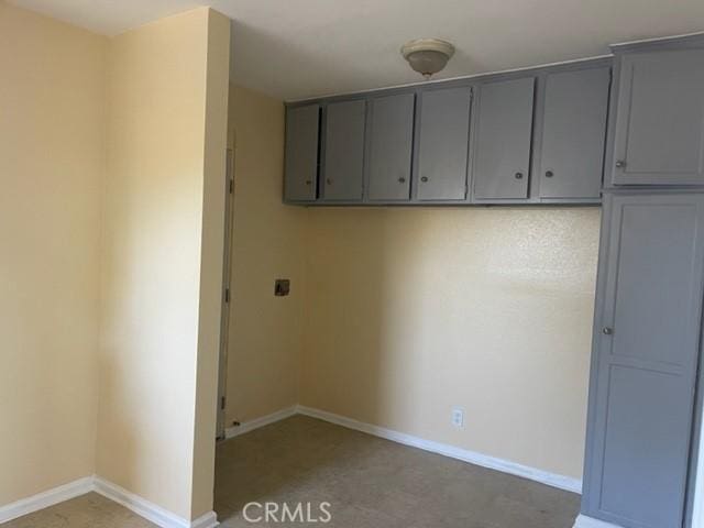 washroom with baseboards