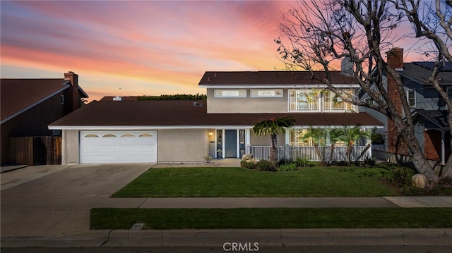 view of front of home featuring driveway, a yard, covered porch, stucco siding, and a garage