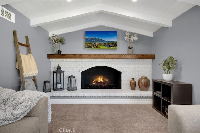 interior space with visible vents, a brick fireplace, and lofted ceiling with beams