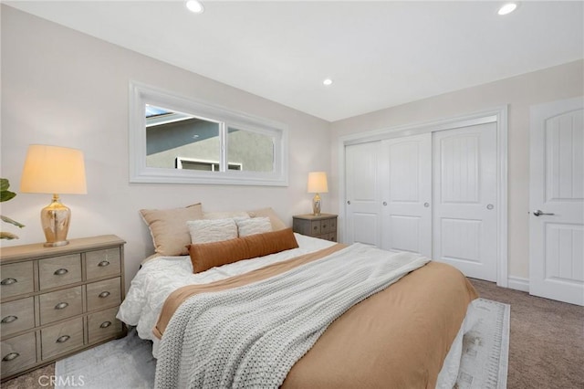 bedroom featuring recessed lighting, a closet, and light carpet