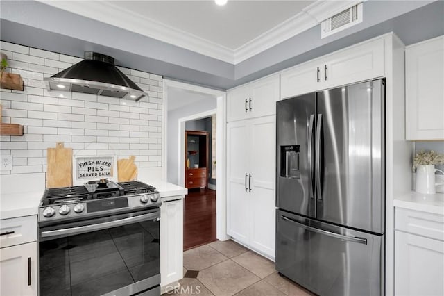 kitchen featuring tasteful backsplash, visible vents, ornamental molding, appliances with stainless steel finishes, and exhaust hood