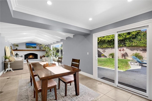 dining area featuring baseboards, lofted ceiling, light tile patterned flooring, recessed lighting, and a brick fireplace