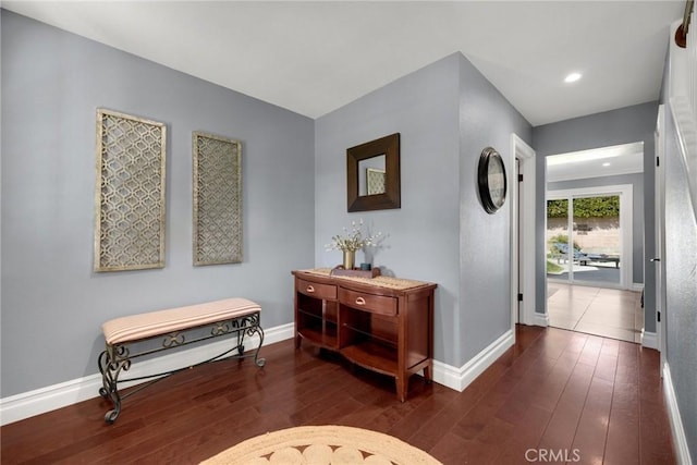 entryway featuring baseboards and wood-type flooring