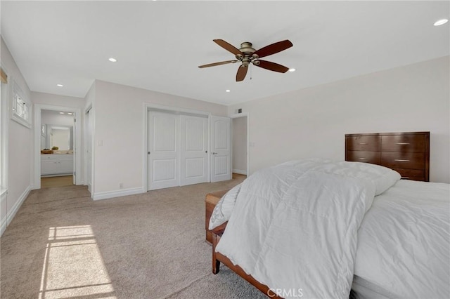 bedroom with light carpet, recessed lighting, a closet, and baseboards