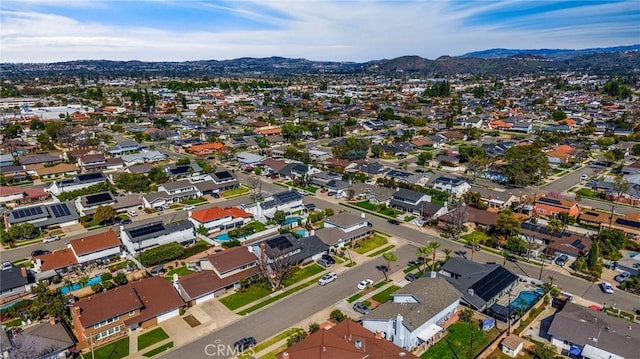 birds eye view of property with a mountain view and a residential view