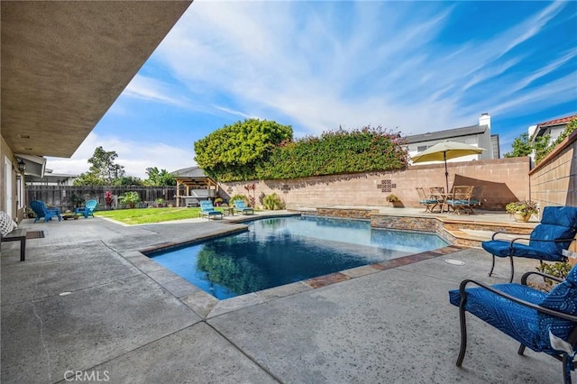 view of pool featuring a patio area, a fenced in pool, and a fenced backyard