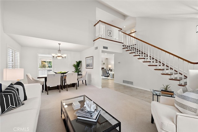 tiled living room featuring visible vents, a notable chandelier, carpet flooring, and stairway