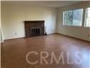 unfurnished living room with a fireplace and baseboards