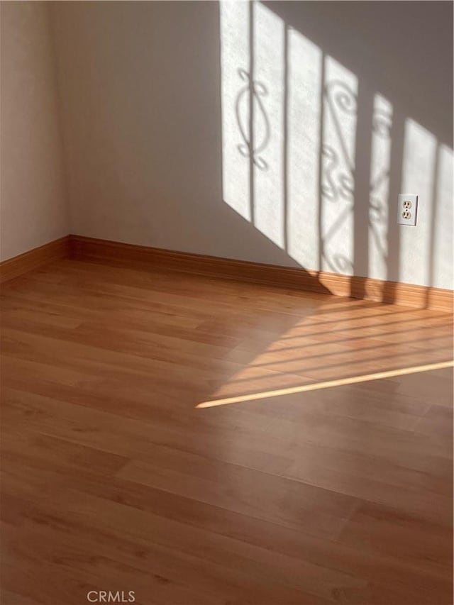 interior space with wood finished floors and baseboards