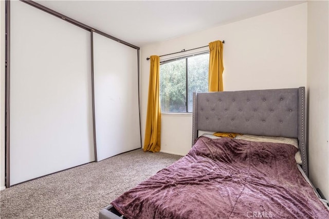 carpeted bedroom with a closet