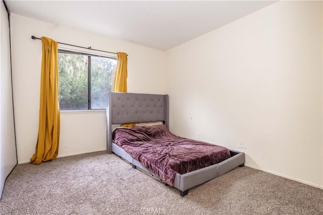 bedroom featuring baseboards and carpet flooring