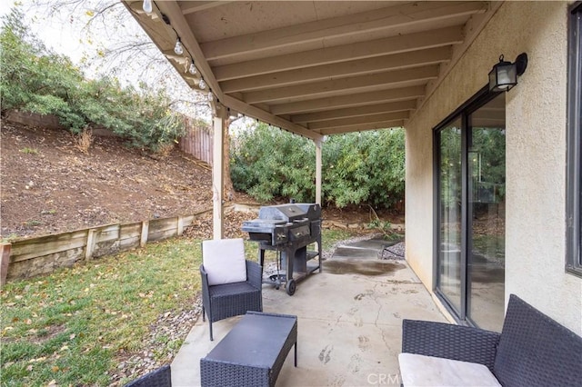 view of patio / terrace featuring fence and grilling area