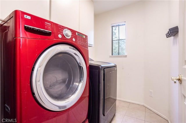 washroom with tile patterned flooring, laundry area, independent washer and dryer, and baseboards