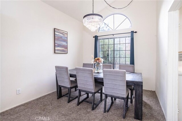 carpeted dining space featuring an inviting chandelier