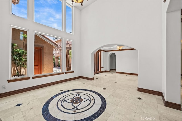 805 E Chase Dr, Corona, CA 92881 - foyer featuring baseboards, arched walkways, and marble finish floor