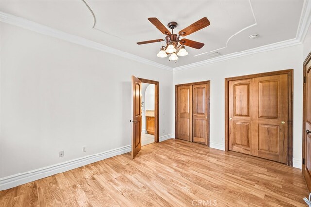 805 E Chase Dr, Corona, CA 92881 - unfurnished bedroom featuring ornamental molding, multiple closets, baseboards, light wood-type flooring, and connected bathroom