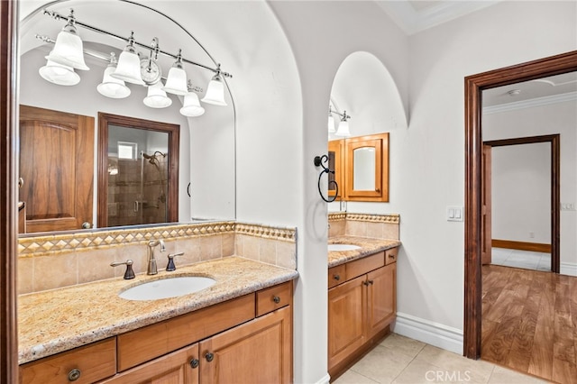 805 E Chase Dr, Corona, CA 92881 - bathroom featuring crown molding, tile patterned flooring, tasteful backsplash, two vanities, and a sink