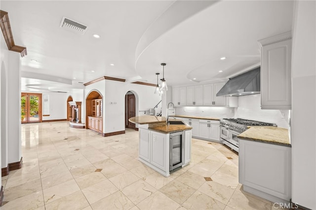 805 E Chase Dr, Corona, CA 92881 - kitchen featuring double oven range, visible vents, beverage cooler, recessed lighting, and wall chimney exhaust hood