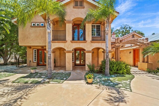805 E Chase Dr, Corona, CA 92881 - mediterranean / spanish house with a pergola, a balcony, stucco siding, and french doors