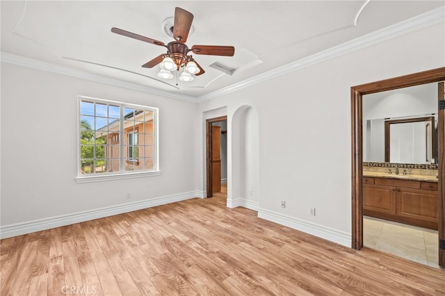 805 E Chase Dr, Corona, CA 92881 - unfurnished bedroom featuring crown molding, arched walkways, baseboards, and light wood-type flooring