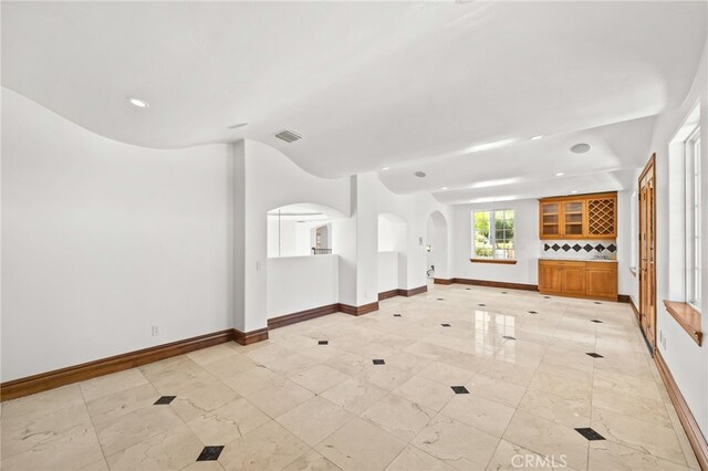 805 E Chase Dr, Corona, CA 92881 - unfurnished living room with baseboards, arched walkways, visible vents, and recessed lighting