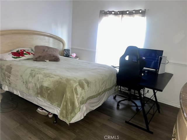 bedroom featuring dark wood-style floors and baseboards