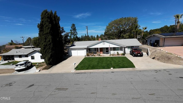 ranch-style house featuring driveway, an attached garage, a chimney, and a front yard