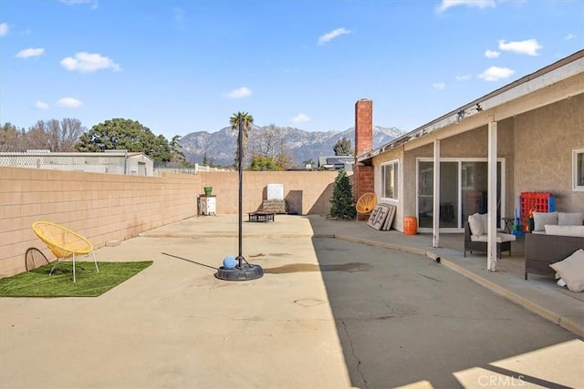 view of patio featuring a fenced backyard and a mountain view