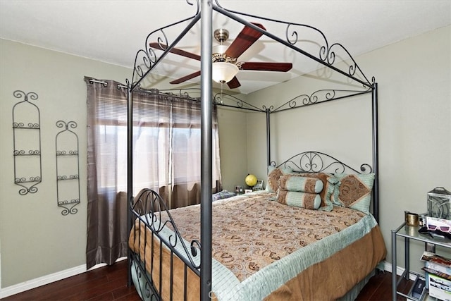 bedroom featuring a ceiling fan, dark wood-type flooring, and baseboards