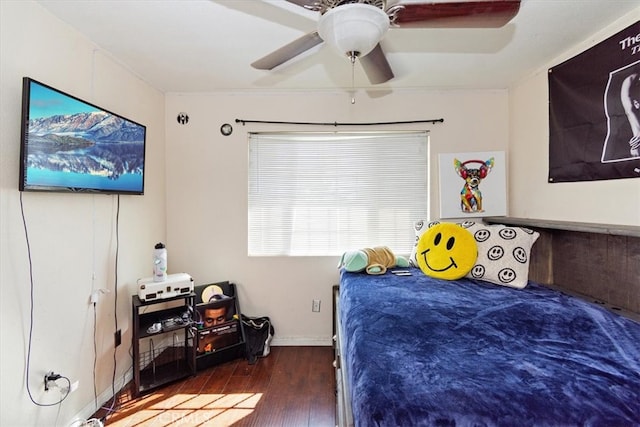 bedroom featuring wood finished floors, baseboards, and ceiling fan