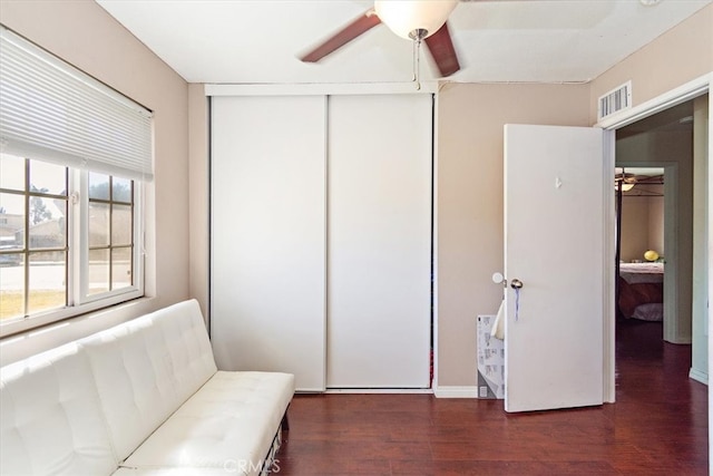 sitting room with wood finished floors, visible vents, and ceiling fan