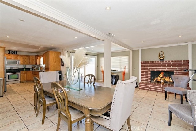 dining area with visible vents, recessed lighting, a fireplace, crown molding, and light tile patterned floors