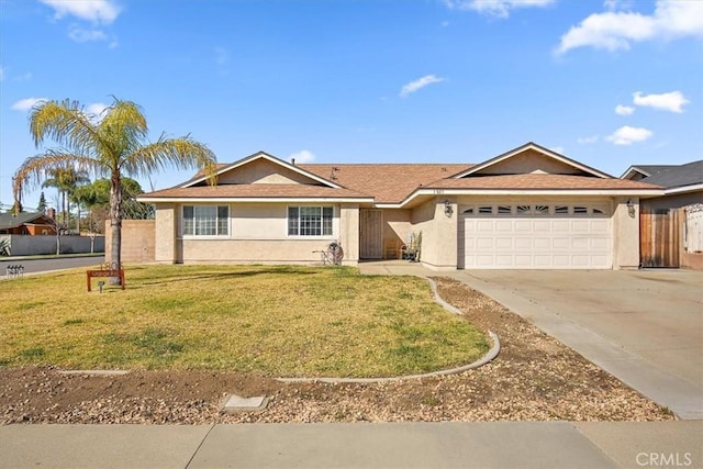 single story home with a front yard, fence, stucco siding, concrete driveway, and a garage